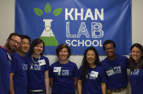 The KLS Team poses in front of a blue banner with the Khan Lab School Logo on Opening Day